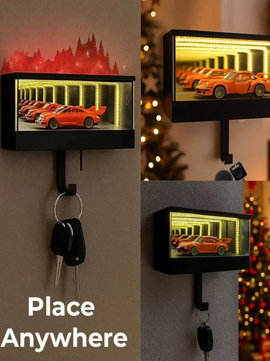 Key holder with a small LED display showing a car garage scene, placed on a wall.
